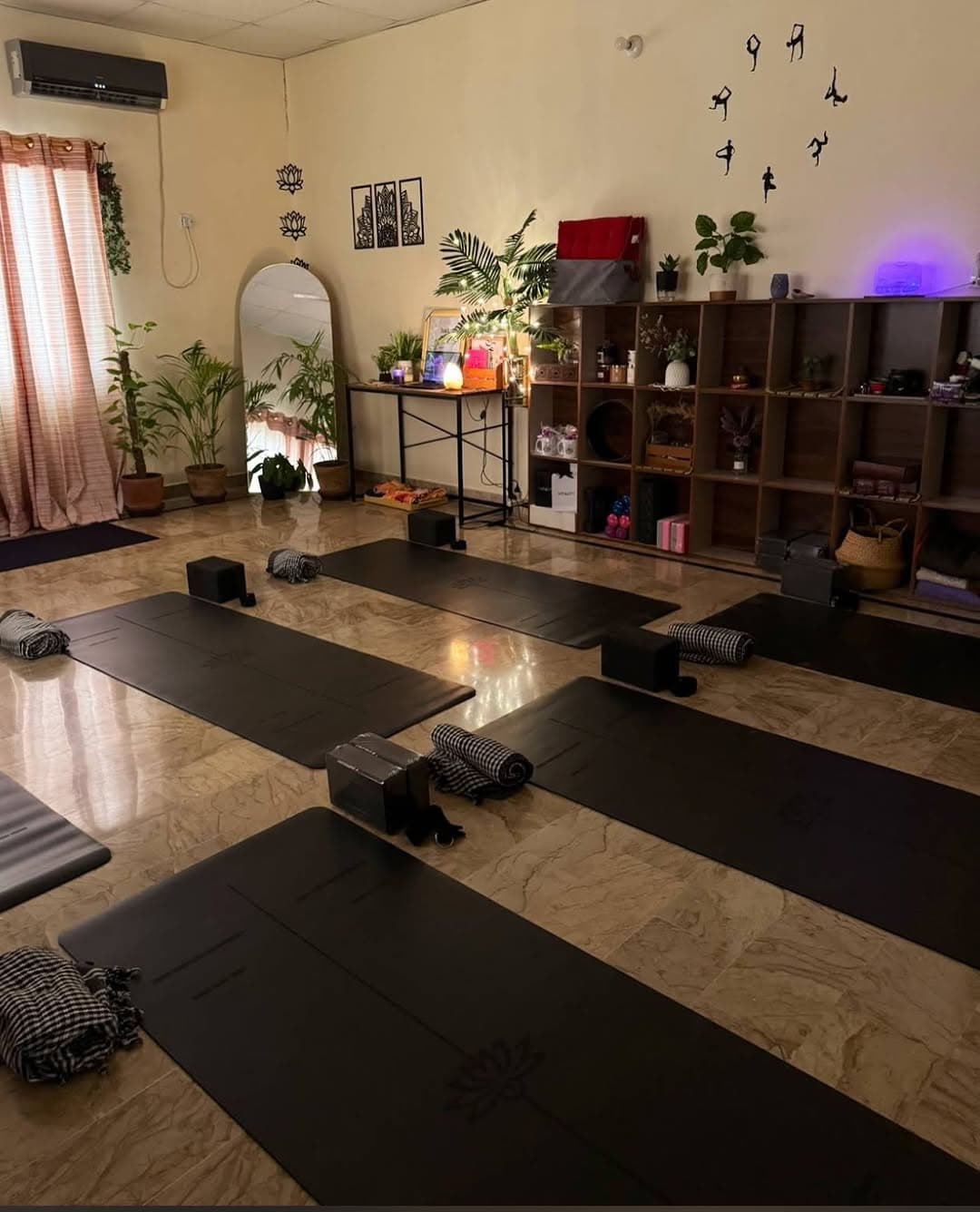 Warm, peaceful yoga studio floor with mats laid out